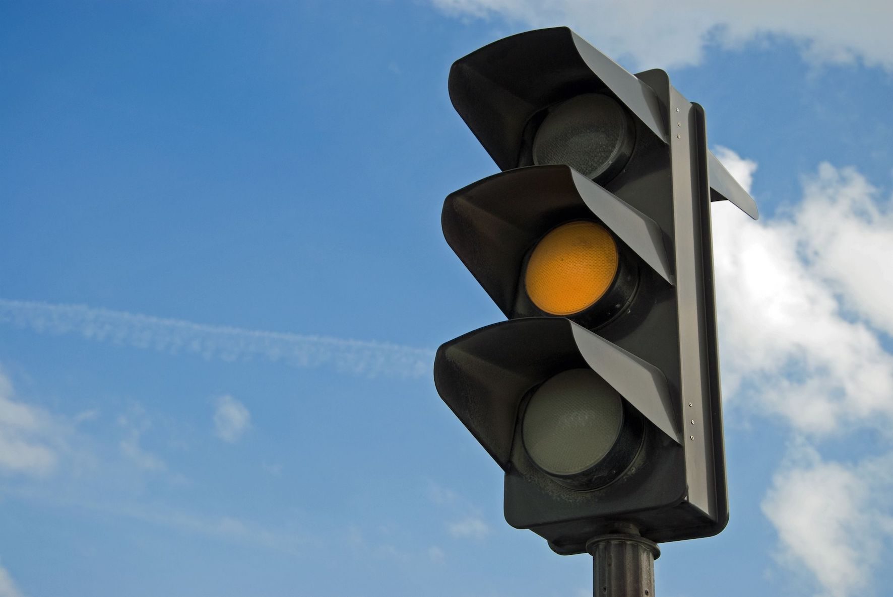 18440202 - amber color on the traffic light with a beautiful blue sky in background